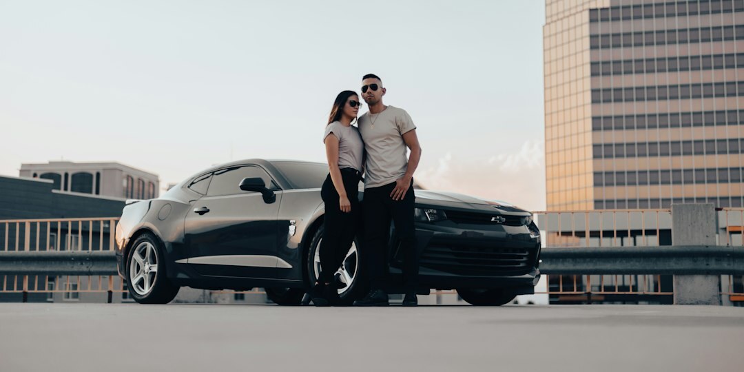 Couple signing a car rental finance agreement with an advisor
