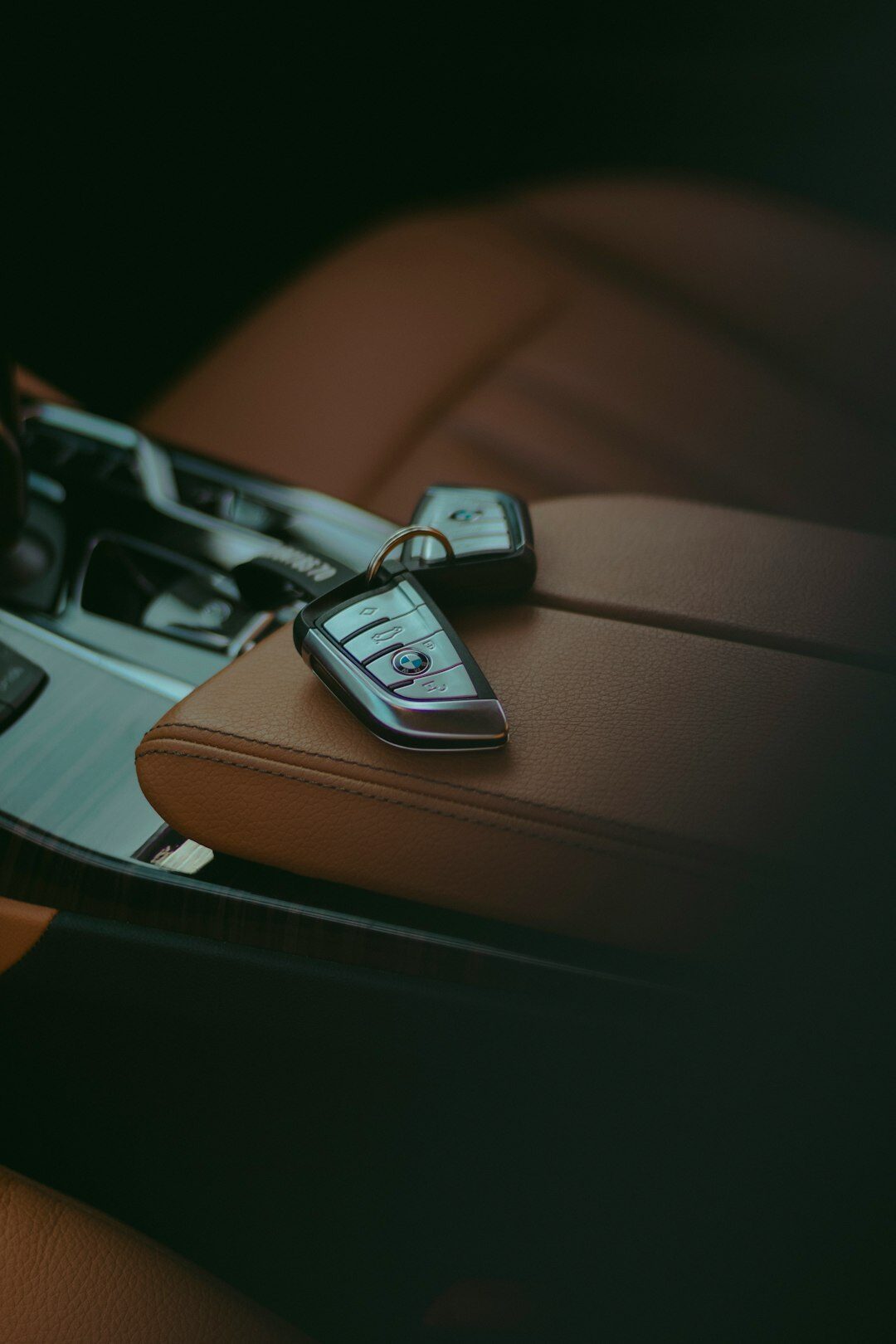 Close-up of a car dashboard with keys and financial documents