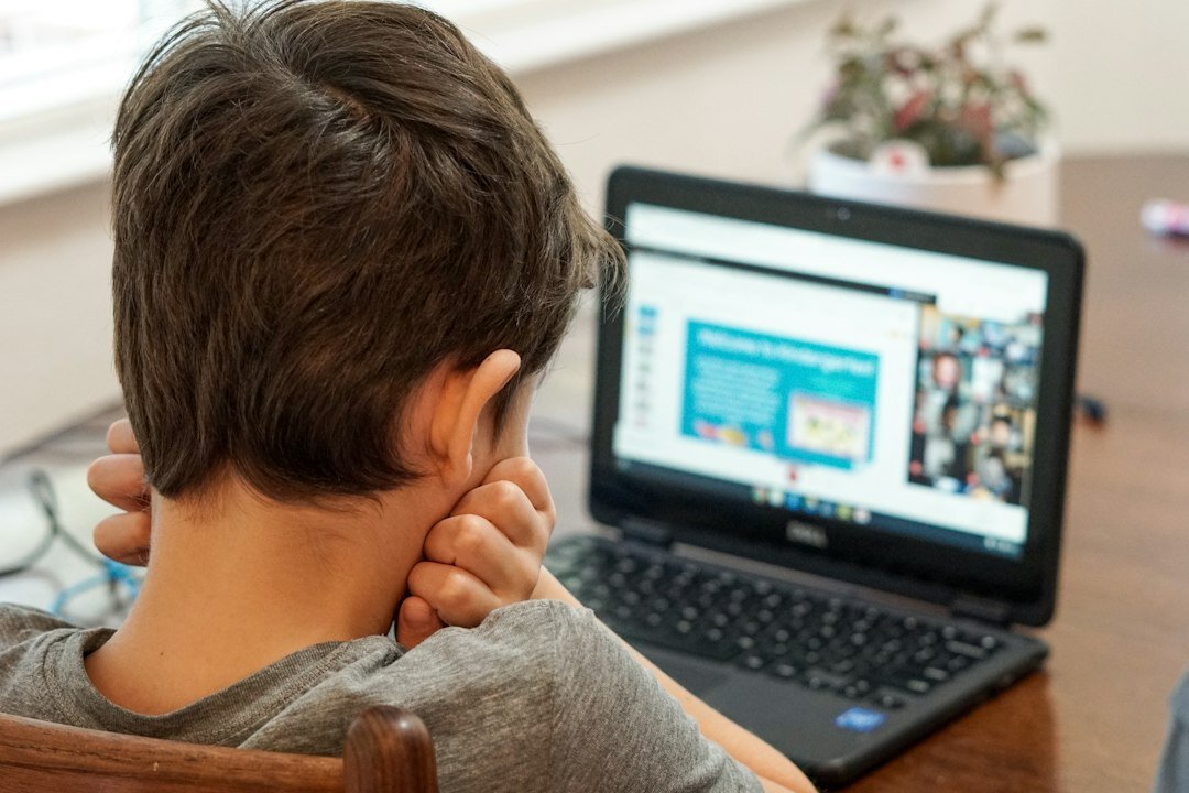 student coding on laptop