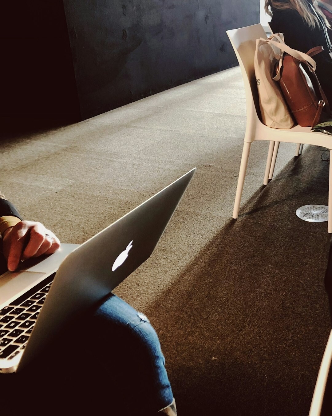 person coding on laptop in english