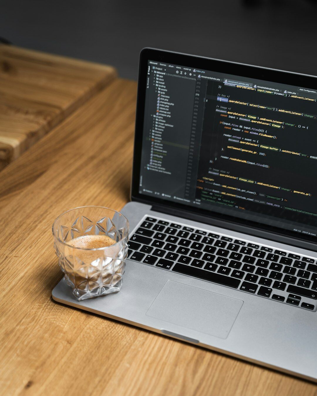 programmer coding on laptop