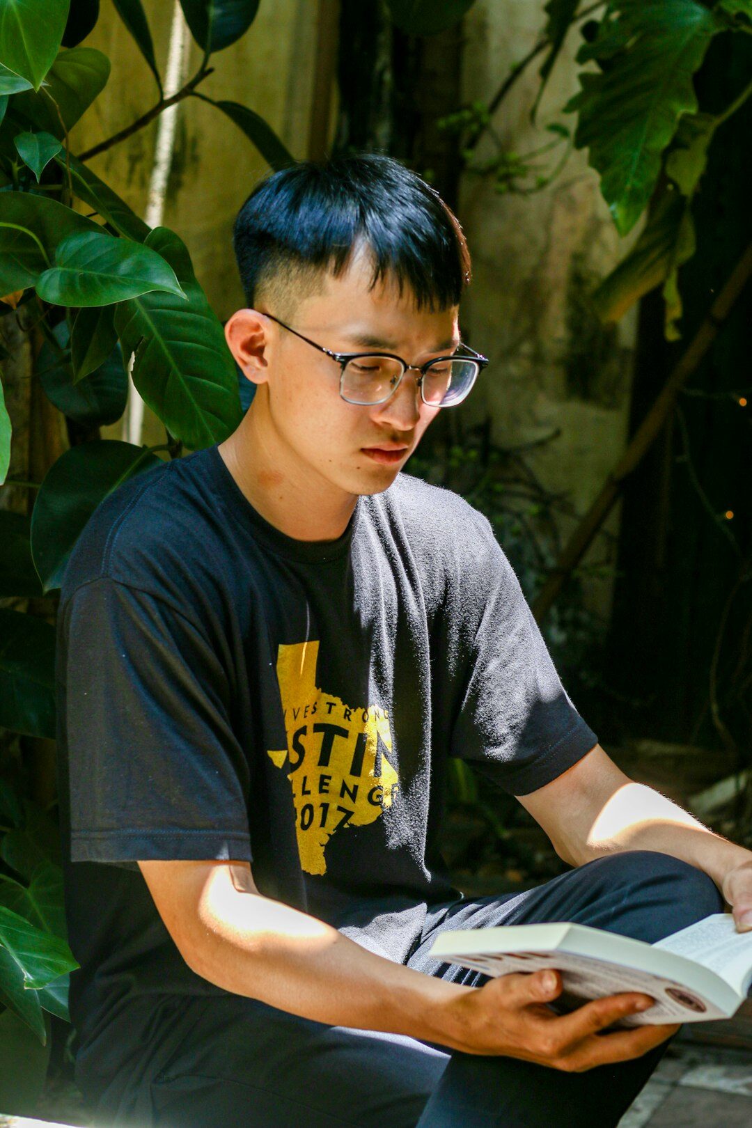 Malay man programming instructor wearing glasses