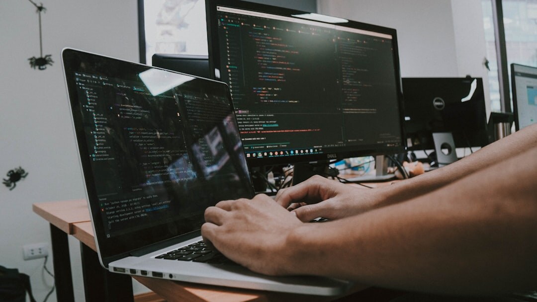 person writing code on laptop