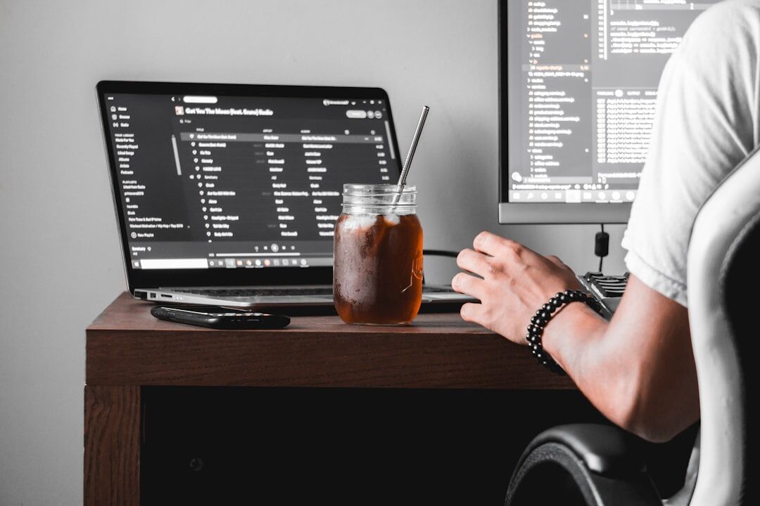 person writing code at desk